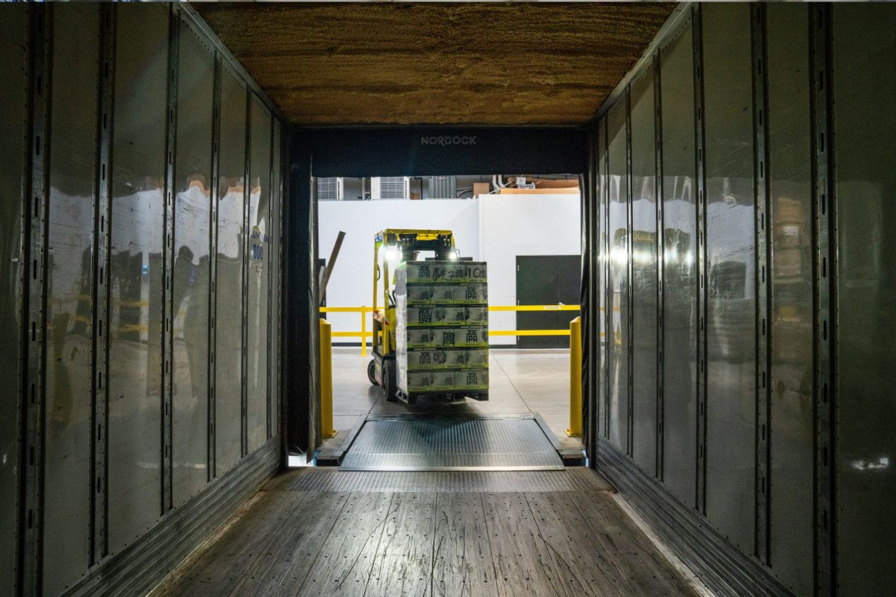 Team unloading and devanning an import container at UKFM's South East London warehouse