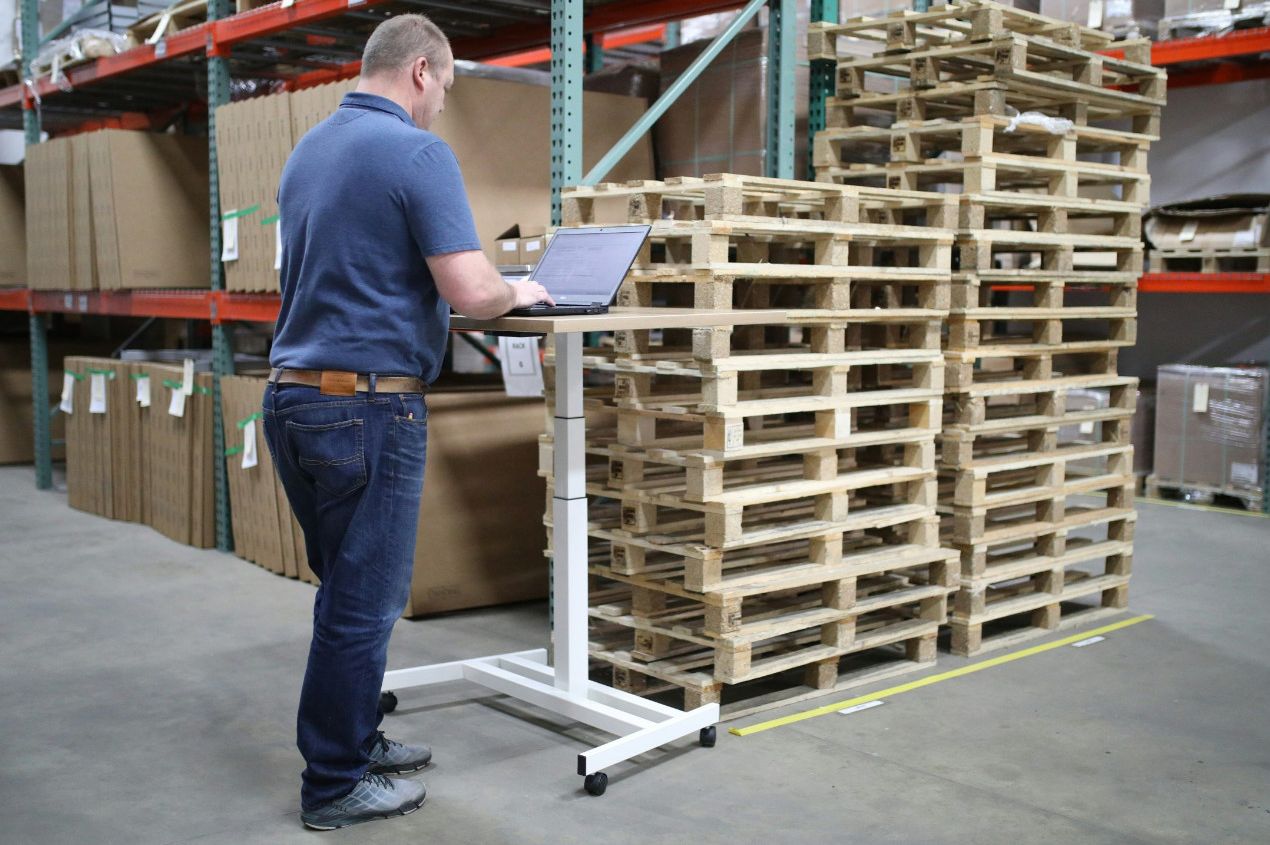 Warehouse operative using a handheld scanner for inventory management and stock control